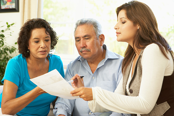 Senior Couple With Options Counselor At Home