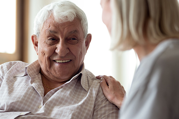 Happy older man feeling relieved after talking to supportive care manager