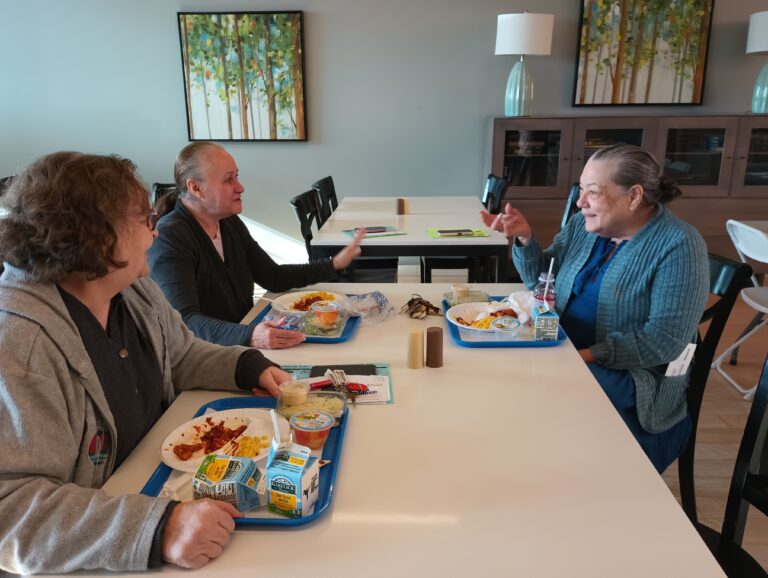 Photo of three women eating together in a supportive housing complex